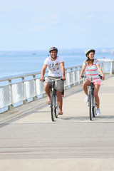 Wall Mural - Family on a biking journey by the sea