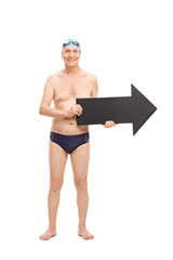 Canvas Print - Senior man in a swim trunks holding an arrow