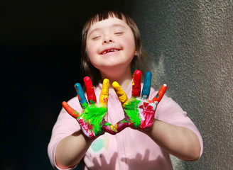 Wall Mural - Cute little girl with painted hands.