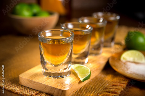 Fotografie, Obraz Close up of agave traditional Tequila shots flight with cut limes and salt
