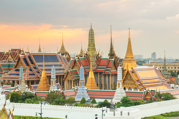 The beauty of the Emerald Buddha Temple at twilight. And while the gold of the temple catching the light. This is an important buddhist temple of thailand and a famous tourist destination.