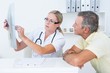 © WavebreakmediaMicro - Doctor showing X rays to her patient