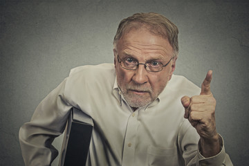 Angry senior man pointing his finger at somebody