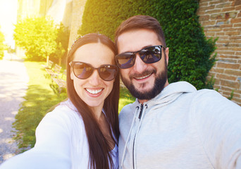 Wall Mural - couple in sunglasses taking selfie