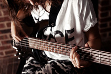Young Adult Girl Playing Five String Bass Guitar. Color Image