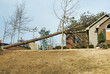 Tornado Damaged House with a Pine Tree on the Roof