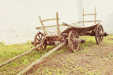 Vintage Old Rough Wooden Cart Near Old Clay Wall.