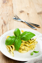 Wall Mural - Cooked homemade pasta with pesto and basil 