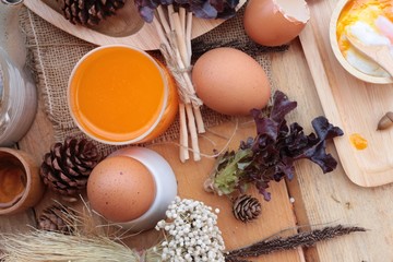 Wall Mural - soft-boiled egg and eggs on wood background