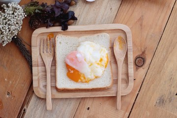 Poster - soft-boiled egg with bread on wood background.