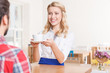 © zinkevych - Smiling waitress giving cup of coffee