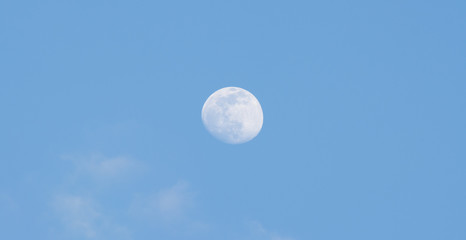the full moon in the sky during the day.