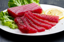 Slices Of Raw Bluefin Tuna  Sashimi On White Dish On Wood Backgr