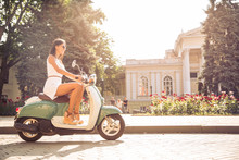 Young Happy Woman Driving Vintage Scooter In Old European Town