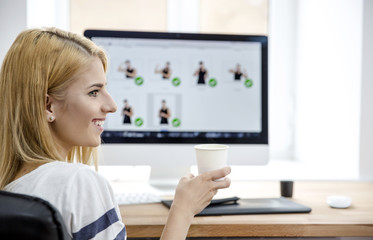 Poster - Happy woman holding cup with coffee in office