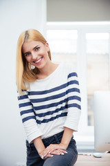 Wall Mural - Happy woman sitting on the table