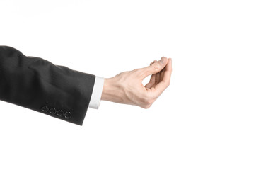 Businessman and gesture topic: a man in a black suit and white shirt showing hand gesture on an isolated white background in studio