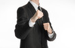 Businessman and gesture topic: a man in a black suit holding his fists in front of him, business struggle
