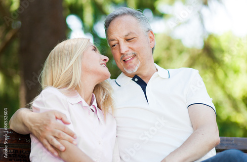 Happy Mature Couple Sitting On A Bench Buy This Stock Photo And