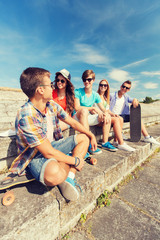 Canvas Print - group of smiling friends sitting on city street