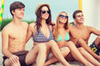 © Syda Productions - smiling friends in sunglasses with surfs on beach