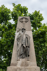 Wall Mural - Statue on entry gate to Poblenou Cemetery in Barcelona, Spain