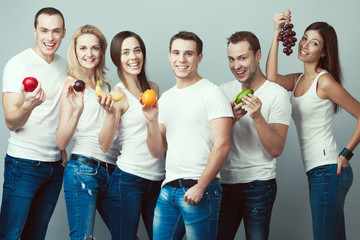 Raw, living food, veggie concept. Group portrait of healthy guys