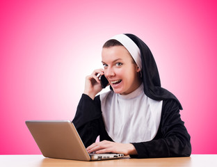 Wall Mural - Nun working on laptop - religious concept