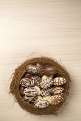 Wall Mural - Chocolate Easter Eggs Over Wooden Background