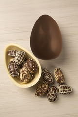 Wall Mural - Chocolate Easter Eggs Over Wooden Background