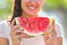 Beautiful Young Woman At Park Eating A Slice Of Watermelon