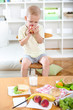© Mediteraneo - Beautiful little boy, eating at home, vegetables on the table
