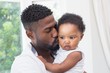 © WavebreakmediaMicro - Happy father with baby girl on couch