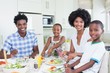 © WavebreakmediaMicro - Happy family sitting down to dinner together