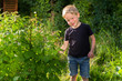 © Yevgeniy Zateychuk - Smiling boy picking raspberries at backyard