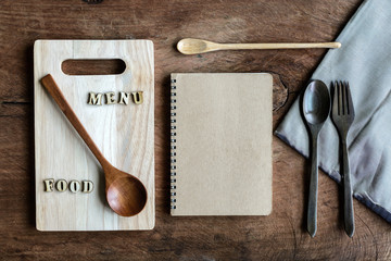 Wall Mural - wooden spoon and fork with note on old wooden background