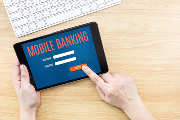 Finger click screen with Mobile banking word with keyboard on wo