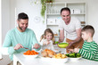 © dglimages - Same sex male couple having dinner with their son and daughter in their home.
