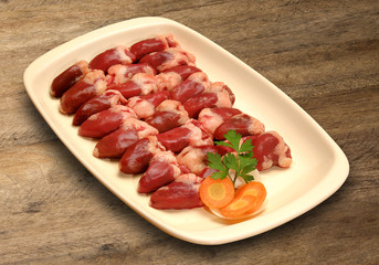 Chicken liver. Raw chicken liver in heart shaped bowl. Macro, cl