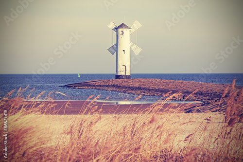 Obraz w ramie Retro vintage stylized lighthouse, Swinoujscie in Poland.