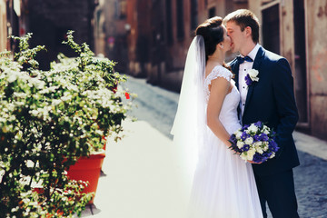 Wall Mural - romantic gentle luxury brunette bride and groom are walking at t