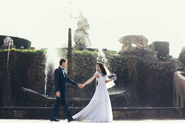 Wall Mural - cute couple full in love on the background wonderful fountain in