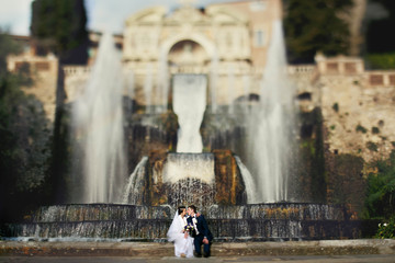 Wall Mural - cute couple full in love on the background wonderful fountain in