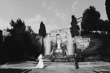 Wall Mural - cute couple full in love on the background wonderful fountain in