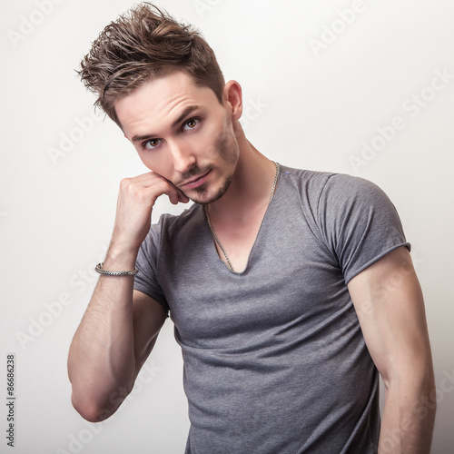 Fototapeta na wymiar Portrait of young handsome man in grey t-shirt.
