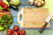Assortment of fresh vegetables and chopping board