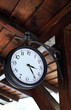 Antique clock hanging on the wooden beam