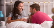 © Monkey Business - Young Couple Relaxing In Bed With Hot Drink