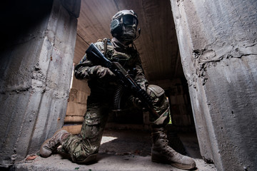 Trooper in military camouflage holding a gun