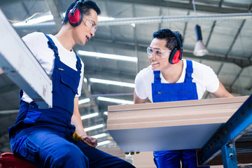 Wall Mural - Asian carpenters in wood workshop at saw